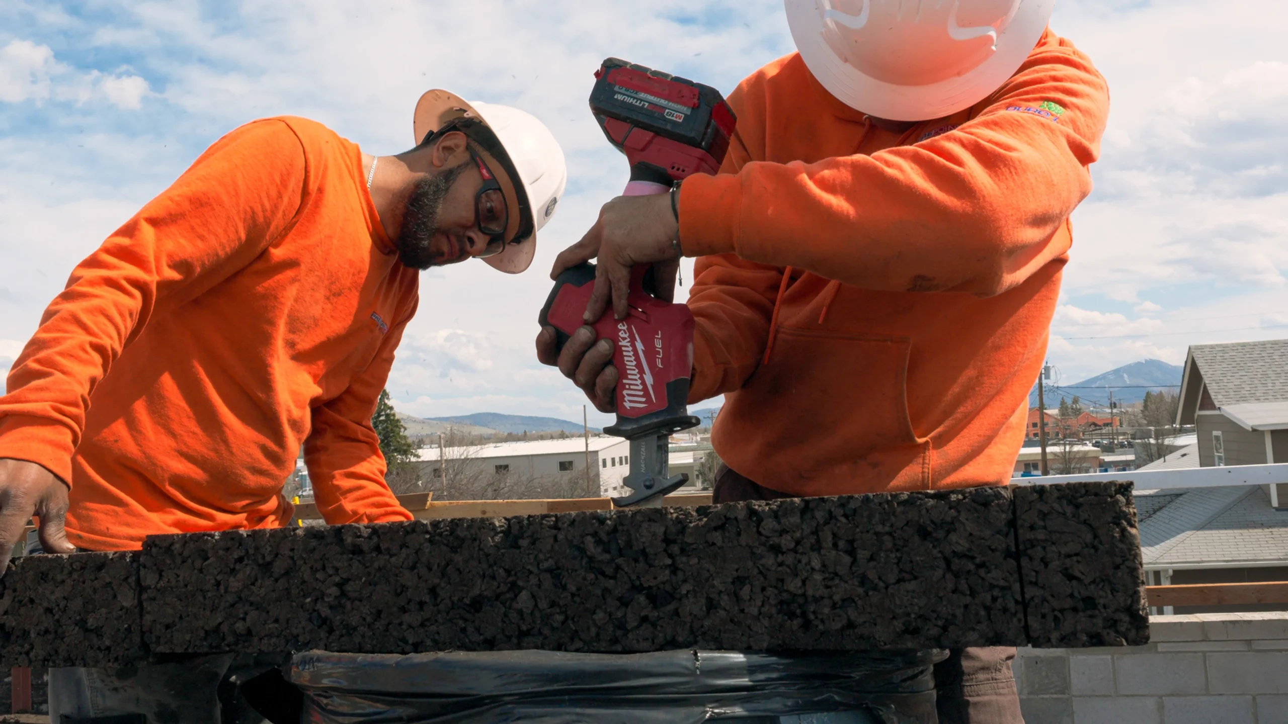 Construction team cutting cork on the roof